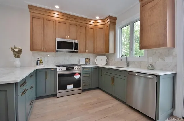 a kitchen with stainless steel appliances granite countertop a sink and a stove top oven