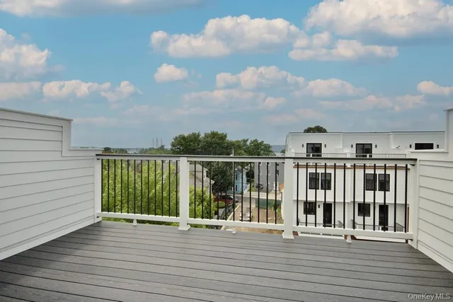 a view of a balcony with wooden floor
