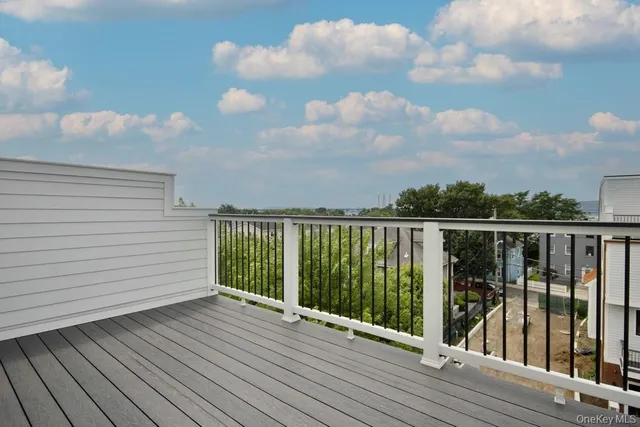 a view of a balcony with wooden floor