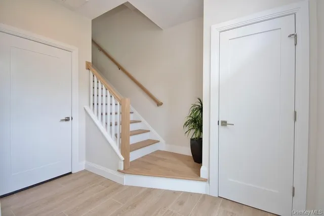 a view of entryway and hall with wooden floor