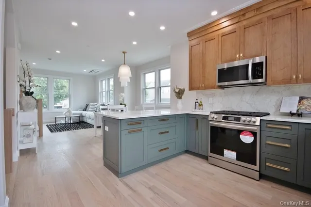 a kitchen with stainless steel appliances granite countertop a stove and a sink