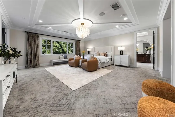 a living room with furniture a fireplace and a large window