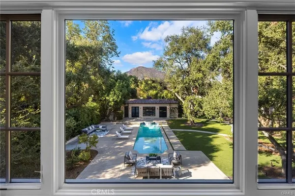 a spacious bedroom with a bed large window and couch