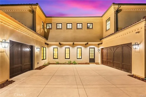 a view of a hallway with a couch and chandelier