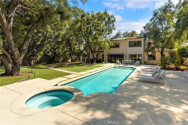a dining room with furniture potted plants and wooden floor