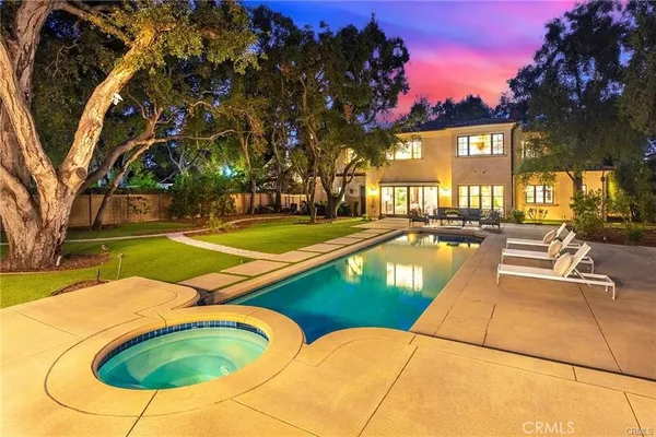 an aerial view of a residential houses outdoor space and swimming pool