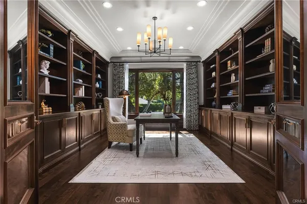 a kitchen with kitchen island granite countertop a sink cabinets and wooden floor