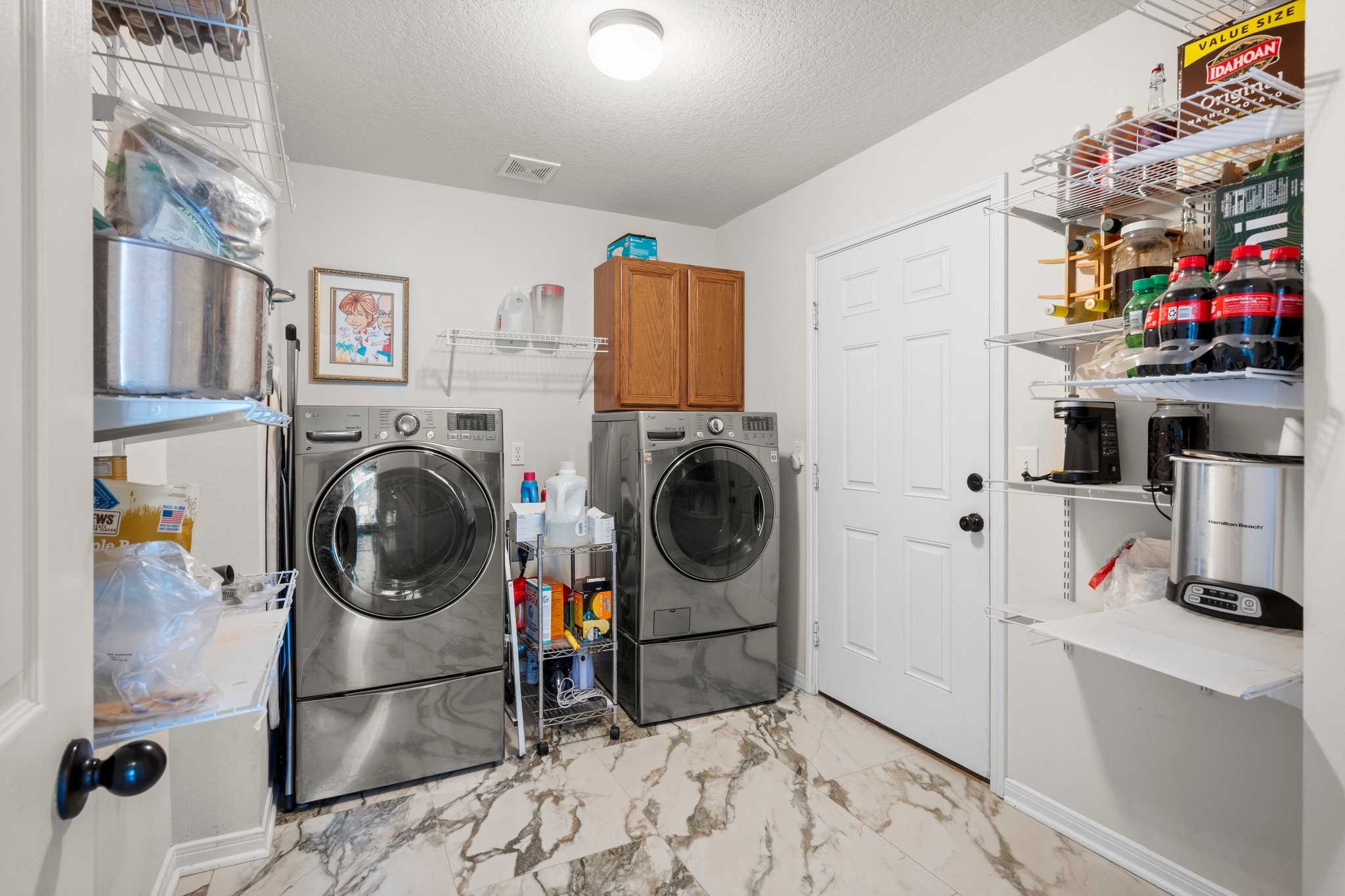34334 Howell Road Waller, TX 77484 - Photo 21 of 37 Enjoy the convenience of this dedicated laundry room, complete with space for a washer and dryer and shelving to keep essentials organized.