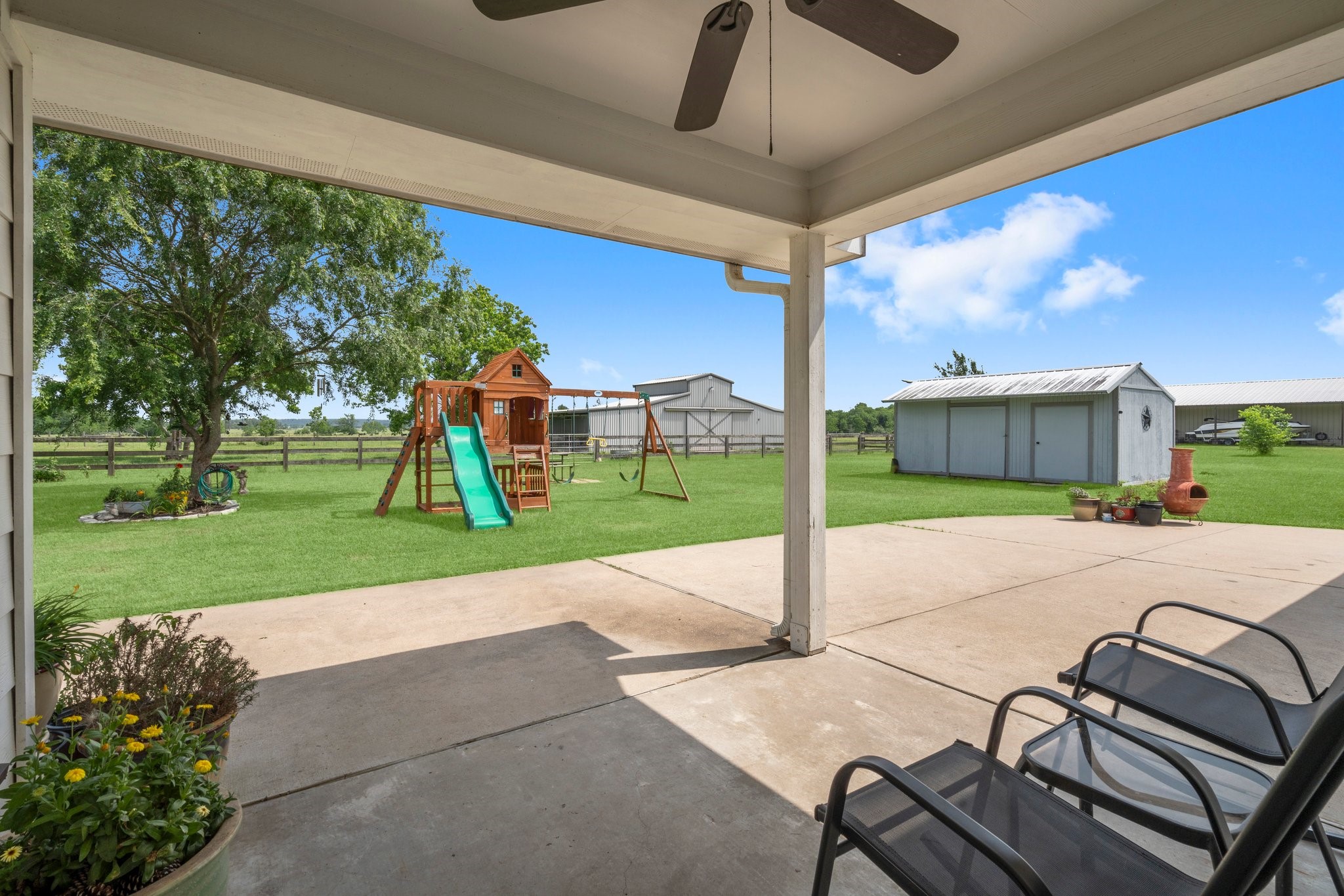 34334 Howell Road Waller, TX 77484 - Photo 24 of 37 Extend your living space outdoors with this covered patio, providing a comfortable area to relax and enjoy the backyard in any weather.