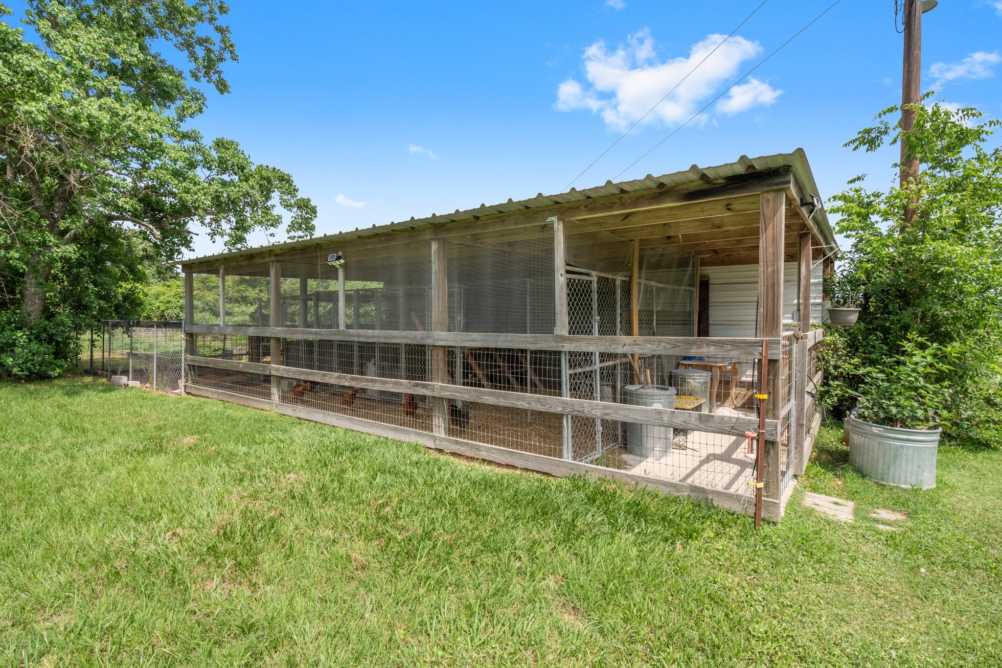 34334 Howell Road Waller, TX 77484 - Photo 27 of 37 This chicken coop features a covered run and enclosed shelter, providing a safe and protected environment for your chickens.