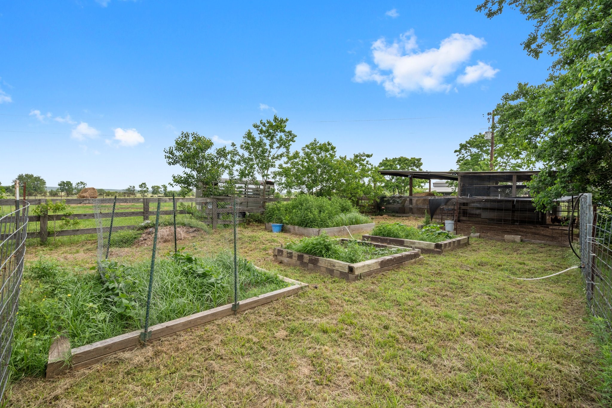 34334 Howell Road Waller, TX 77484 - Photo 29 of 37 Enjoy the opportunity to grow your own fresh produce in this dedicated fenced garden with several raised planting beds.