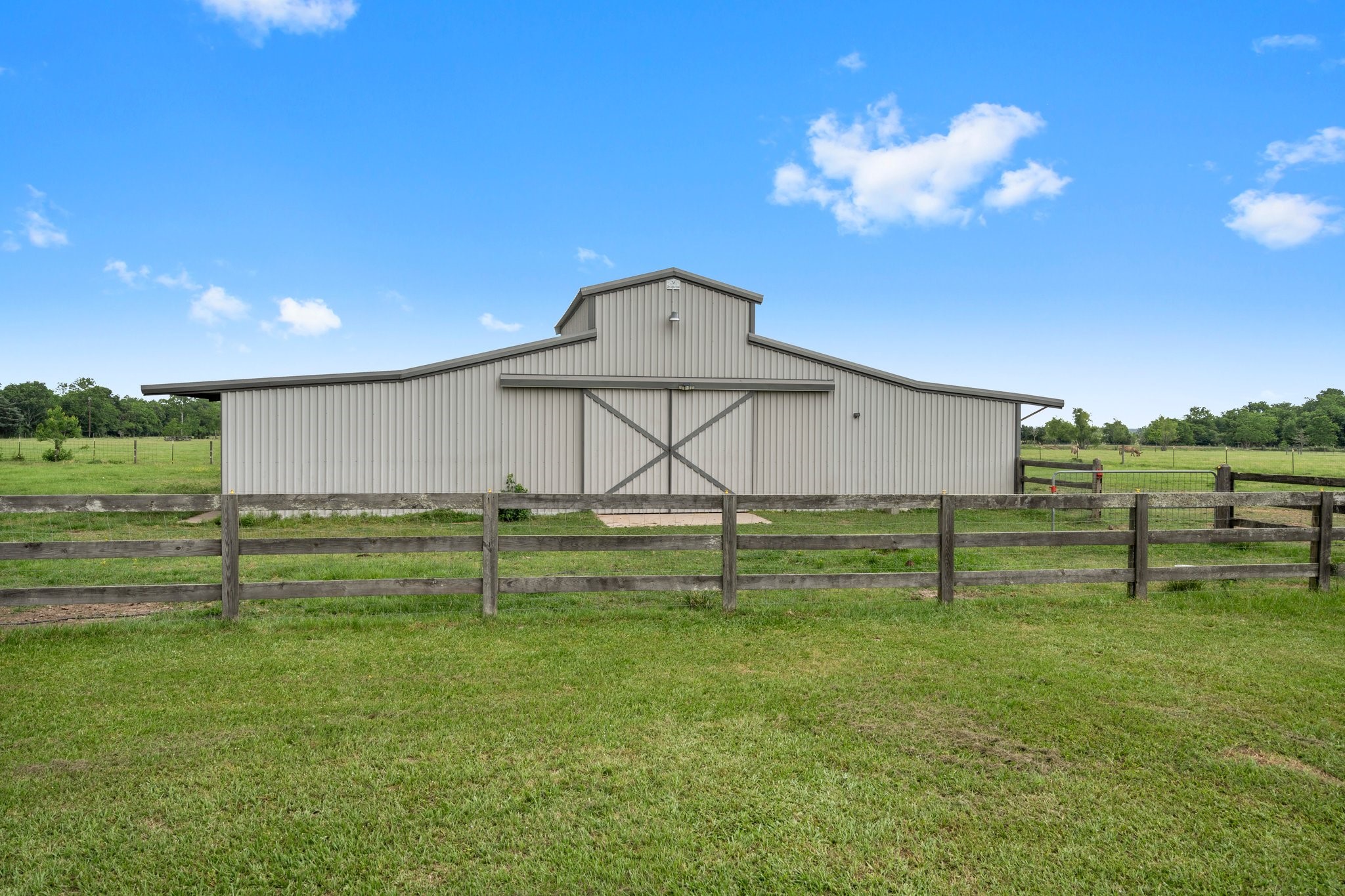 34334 Howell Road Waller, TX 77484 - Photo 31 of 37 Discover the versatility of this large barn, providing significant space for equipment storage, livestock shelter, or the development of your hobbies and interests.