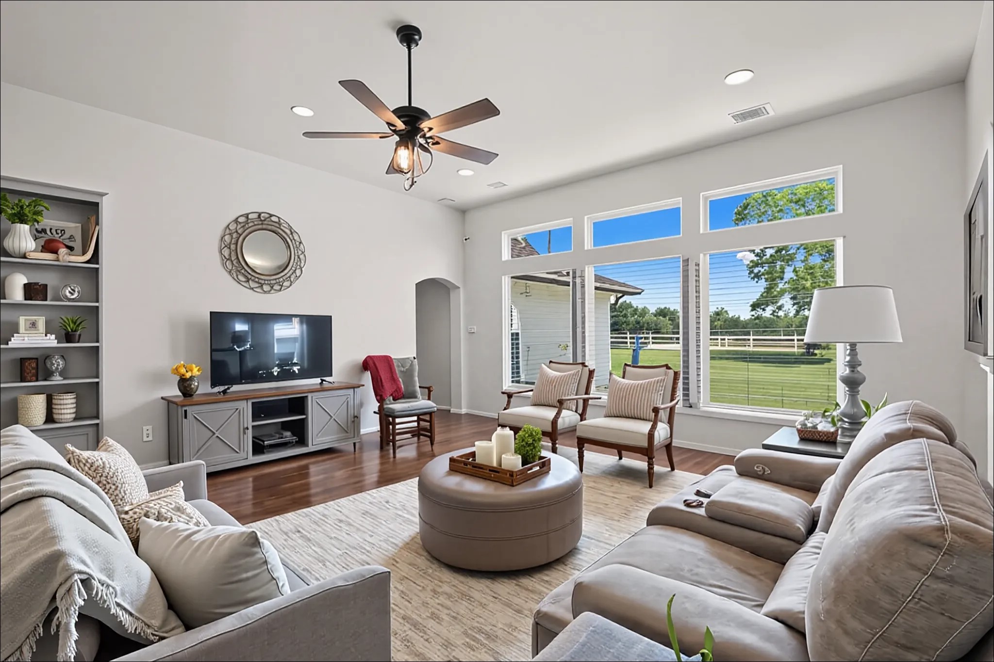 34334 Howell Road Waller, TX 77484 - Photo 9 of 37 Enjoy the bright and airy atmosphere of this spacious living room, featuring large windows that flood the area with natural light and offer views of the surrounding landscape. It's the perfect space for relaxation and comfortable living.