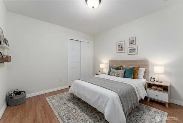 a bedroom with a bed and wooden floor