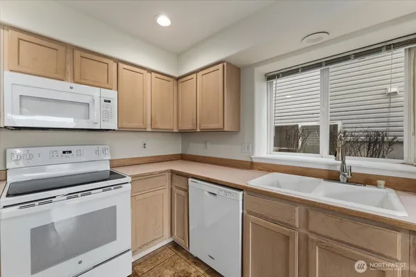 a kitchen with appliances cabinets and a sink