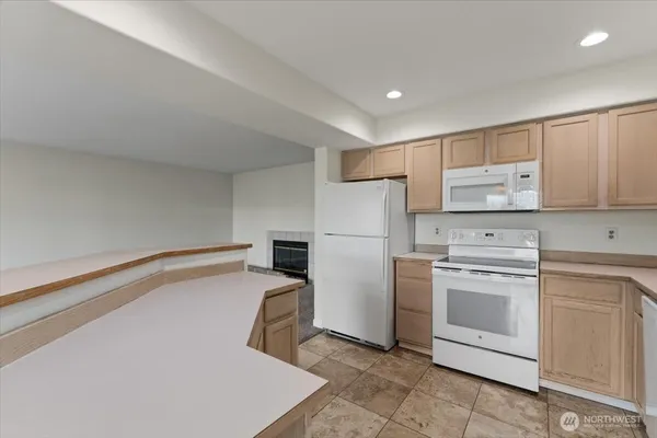 a kitchen with a stove top oven and refrigerator