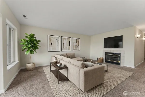 a living room with furniture a potted plant and a fireplace