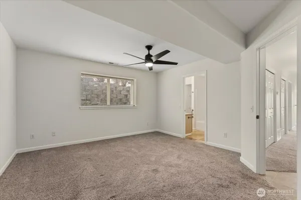 a view of an empty room with a ceiling fan