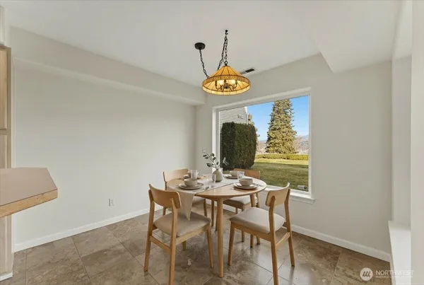 a view of a dining room with furniture and window