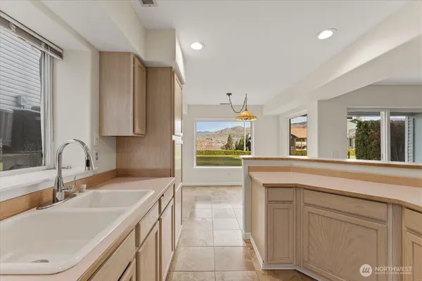 a kitchen with a sink stove and cabinets