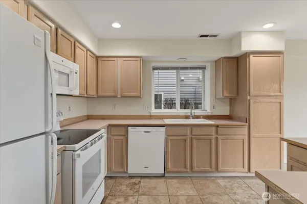 a kitchen with a sink stove and refrigerator