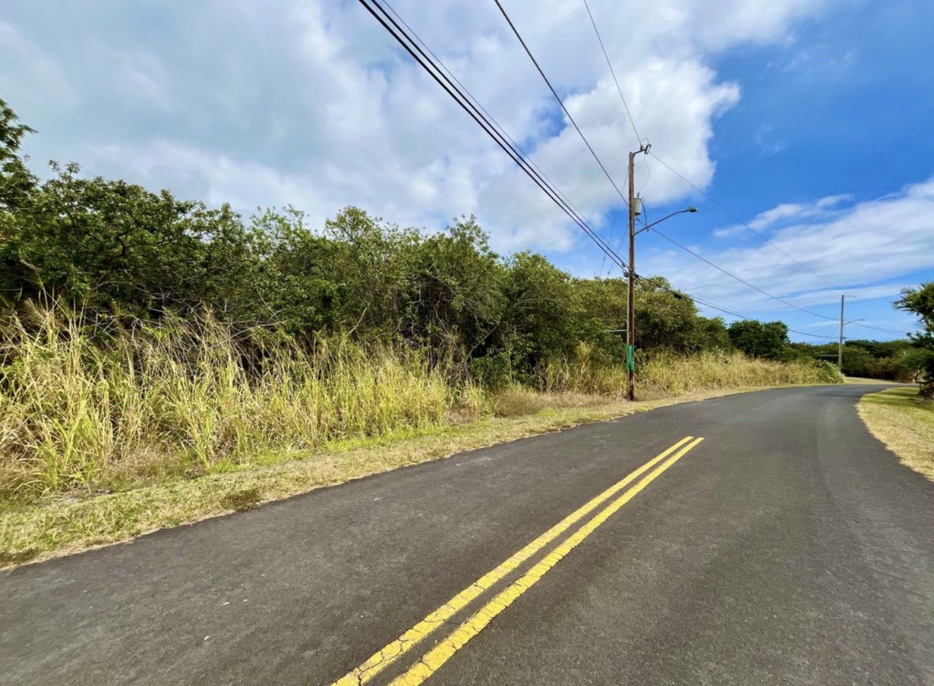 384 Kaulua Street Naalehu, HI 96772 - Photo 5 of 12 a view of a street with a building in the background