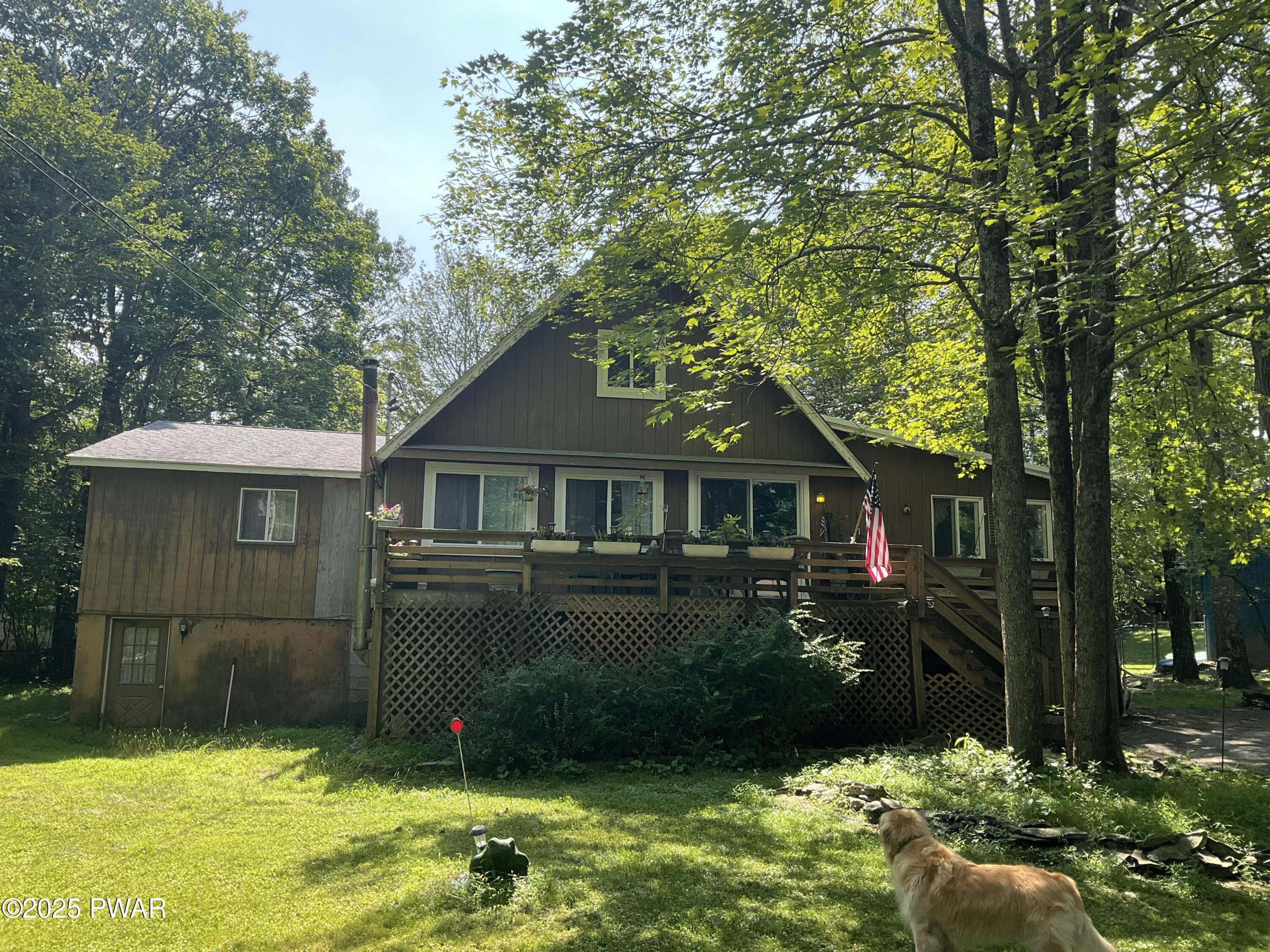 124 Roundhill Road Dingmans Ferry, PA 18328 - Photo 3 of 47 a front view of a house with a garden