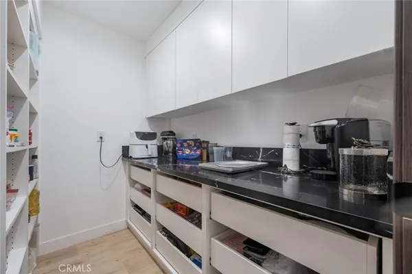 a kitchen with refrigerator and cabinets
