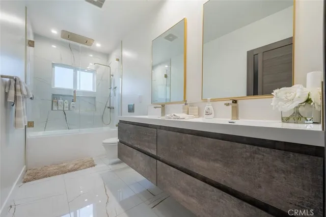 a bathroom with a bathtub sink and mirror