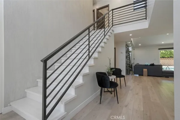 a view of a livingroom with furniture and stairs