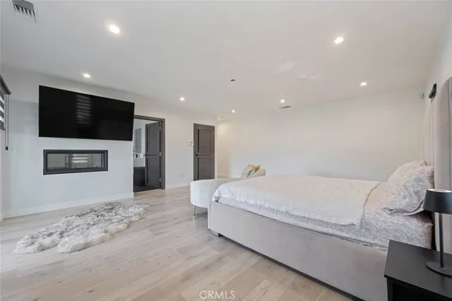 a living room with a bed and a flat screen tv