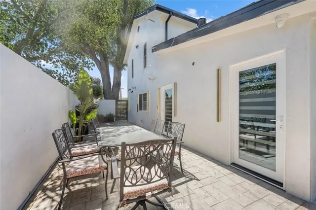 a view of a patio with table and chairs and potted plants