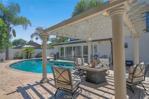 a view of a house with swimming pool and porch