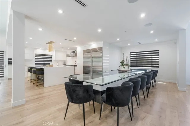 a kitchen with stainless steel appliances kitchen island granite countertop a table and chairs