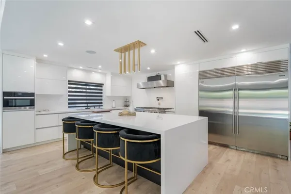 a kitchen with a sink stainless steel appliances and cabinets