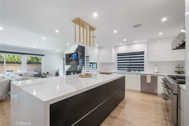 a kitchen with a sink a stove and cabinets