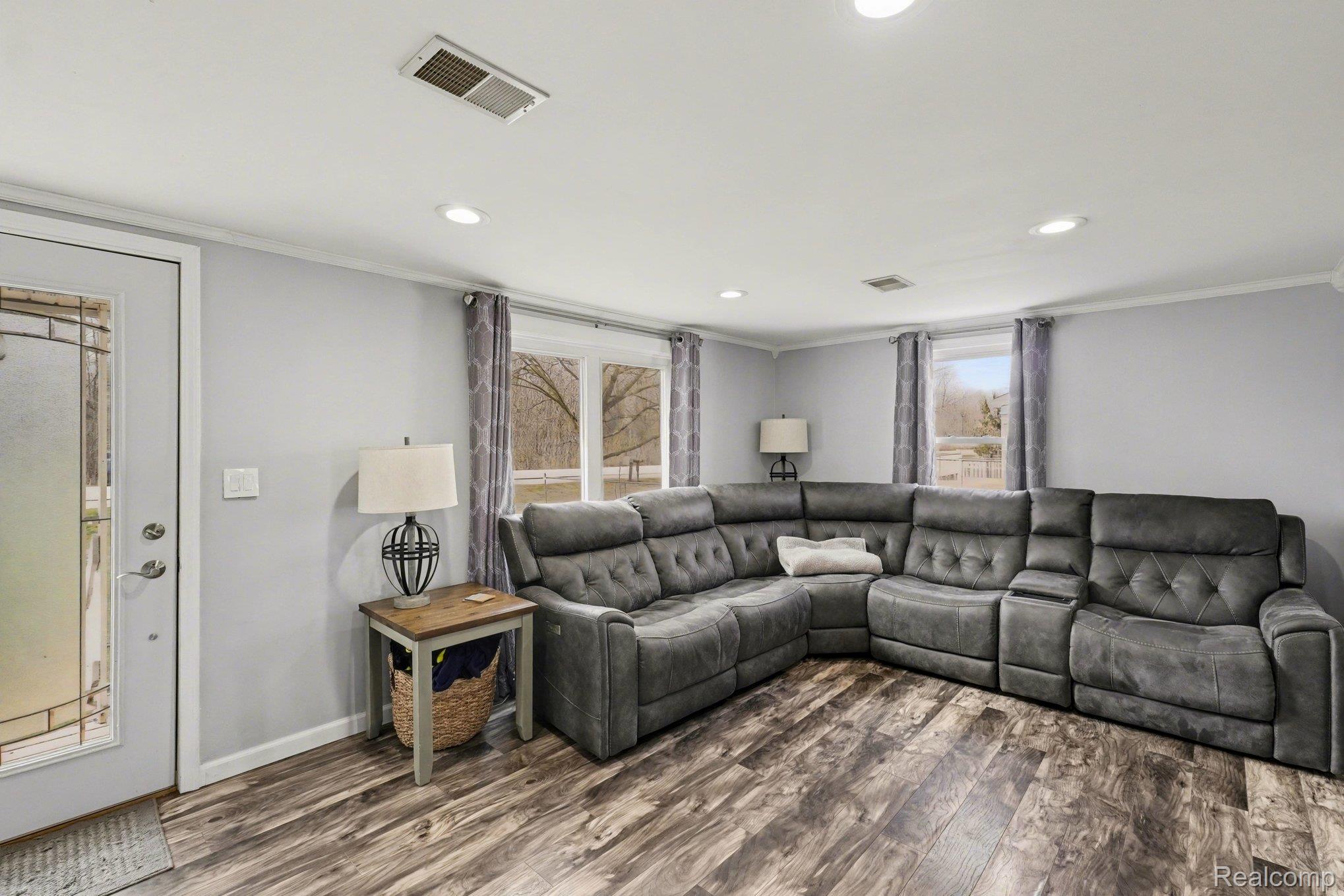 16485 Jennings Road Fenton, MI 48430 - Photo 12 of 27 Living area featuring crown molding, dark wood-style floors, and recessed lighting