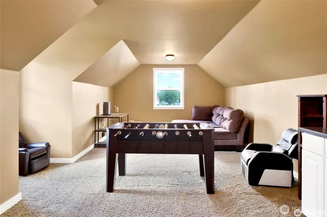 a living room with furniture a rug and a large window