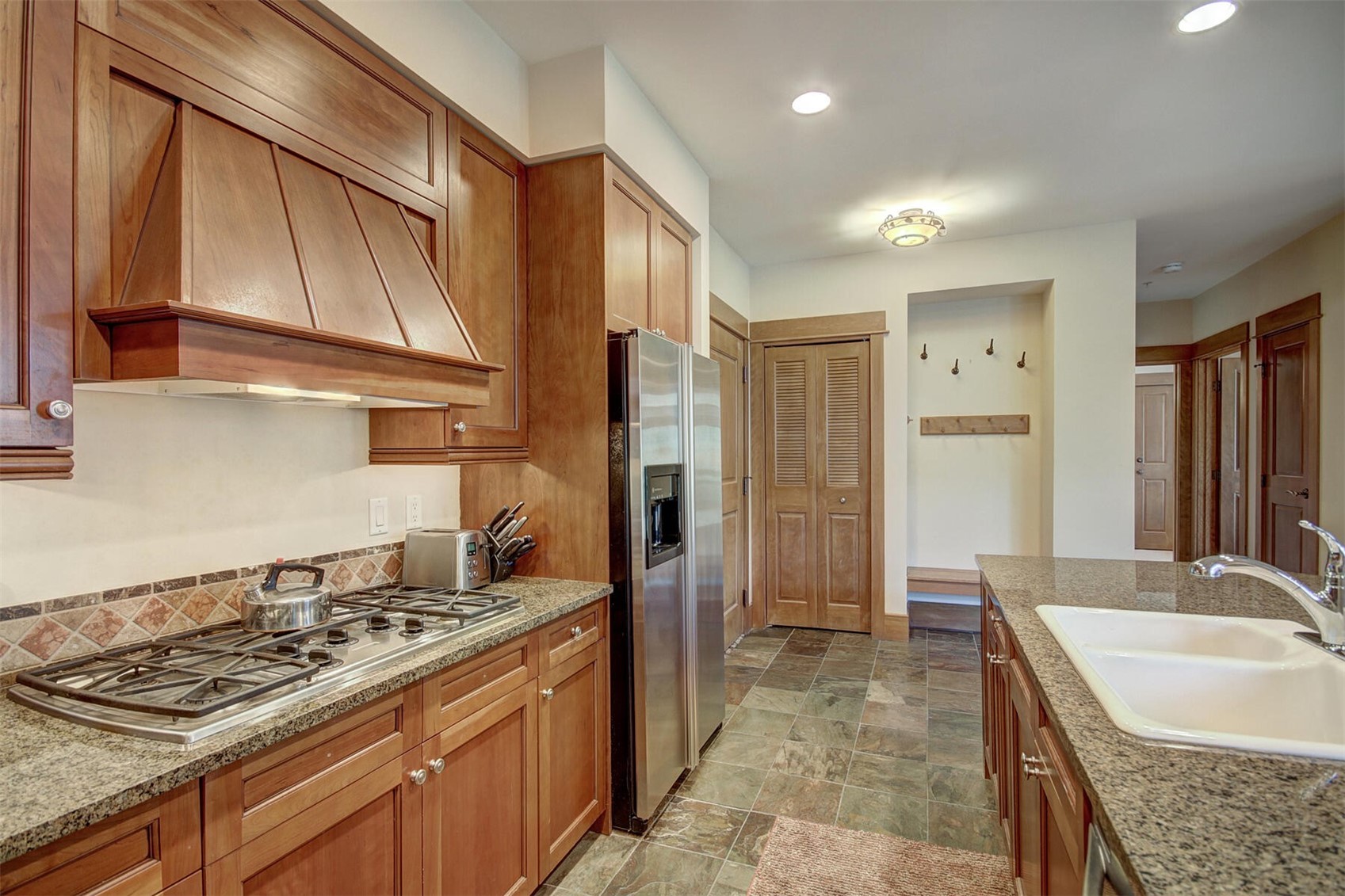 280 Trailhead Drive, Unit 3039 Keystone, CO 80435 - Photo 13 of 38 a kitchen with granite countertop a sink stove and refrigerator