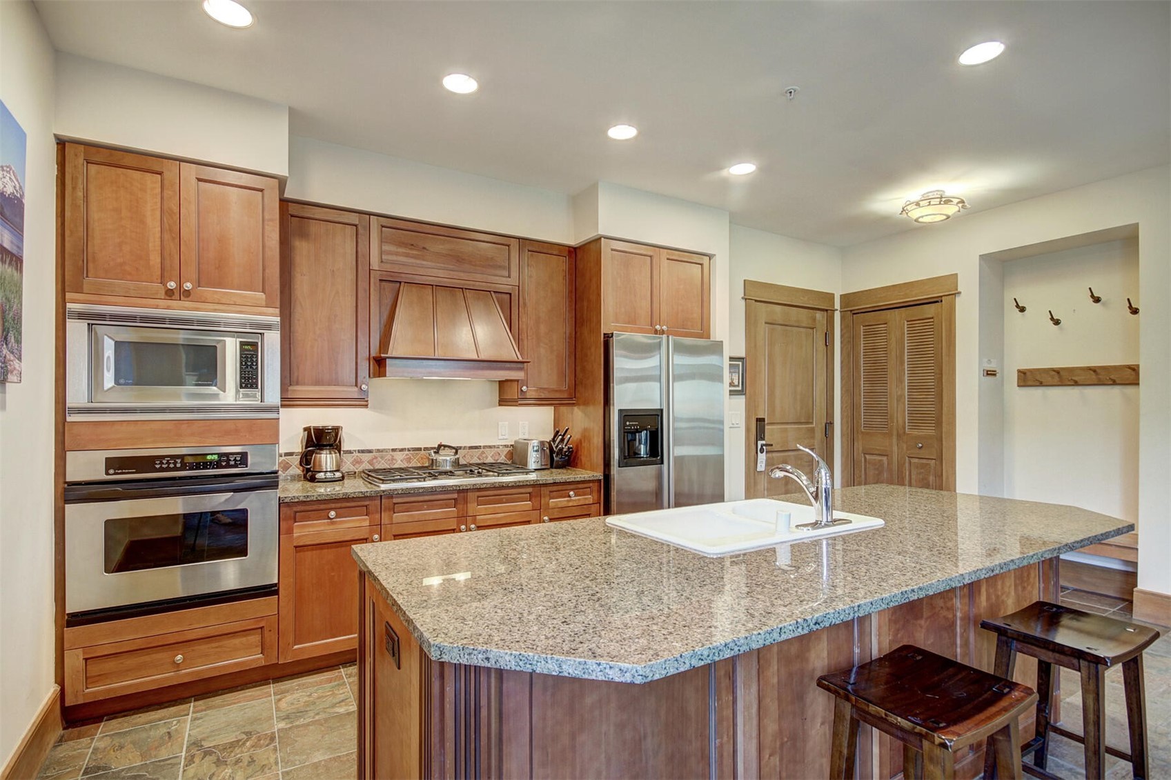 280 Trailhead Drive, Unit 3039 Keystone, CO 80435 - Photo 14 of 38 a kitchen with stainless steel appliances granite countertop a kitchen island a stove and a sink