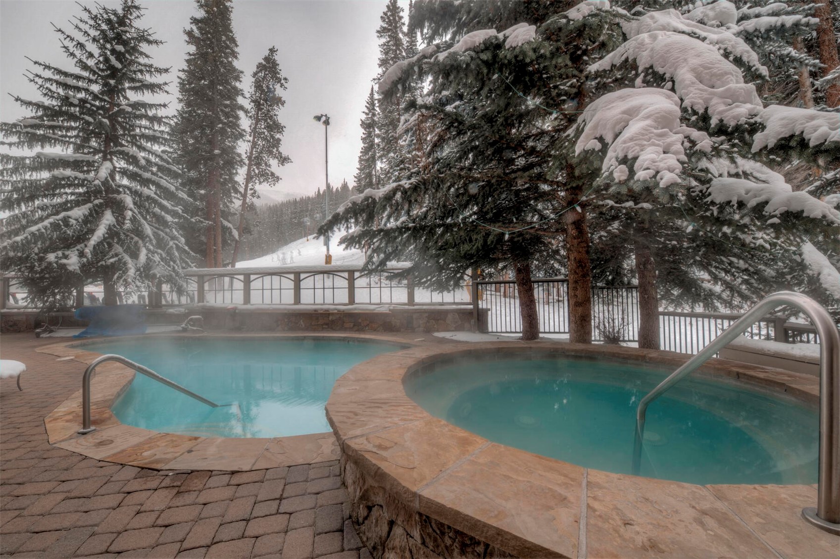 280 Trailhead Drive, Unit 3039 Keystone, CO 80435 - Photo 28 of 38 a swimming pool with outdoor seating and yard
