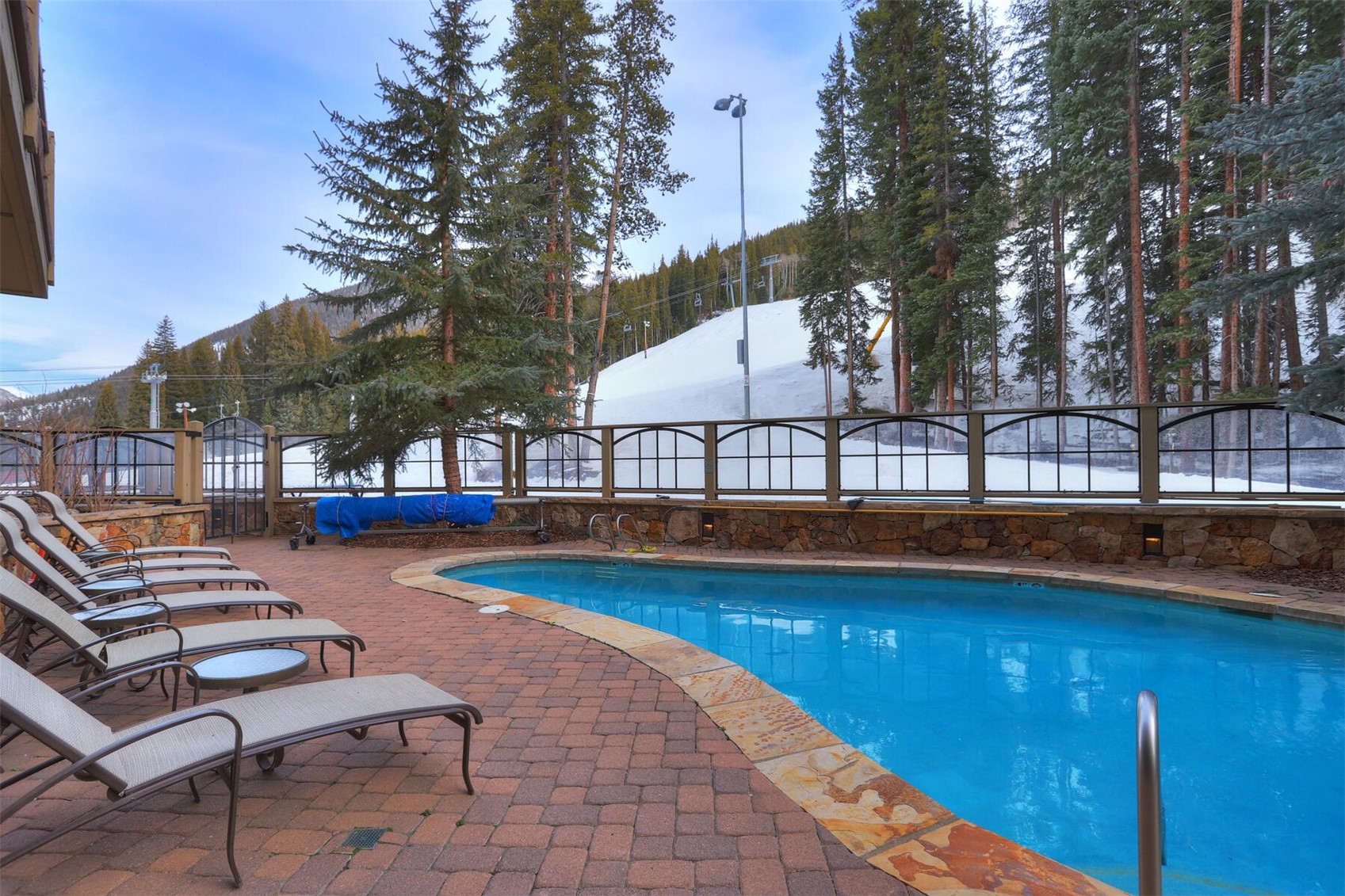 280 Trailhead Drive, Unit 3039 Keystone, CO 80435 - Photo 29 of 38 a view of a swimming pool with a lounge chairs