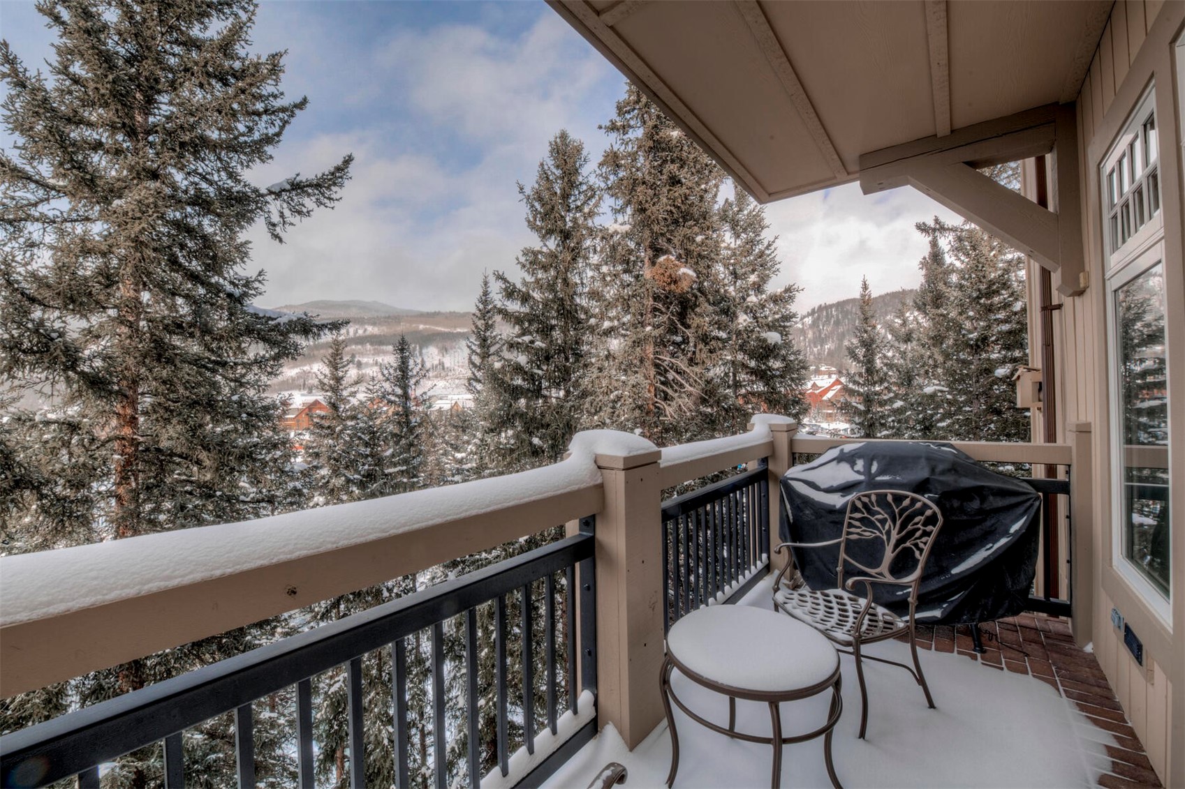 280 Trailhead Drive, Unit 3039 Keystone, CO 80435 - Photo 3 of 38 a view of a balcony with chairs and wooden fence
