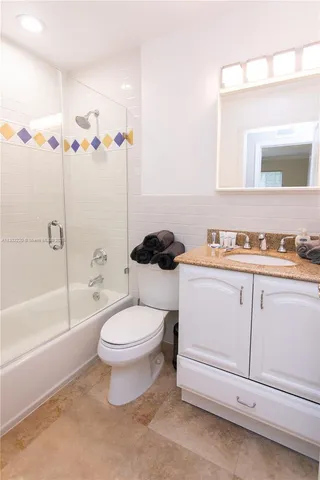 a bathroom with a toilet a sink and bathtub