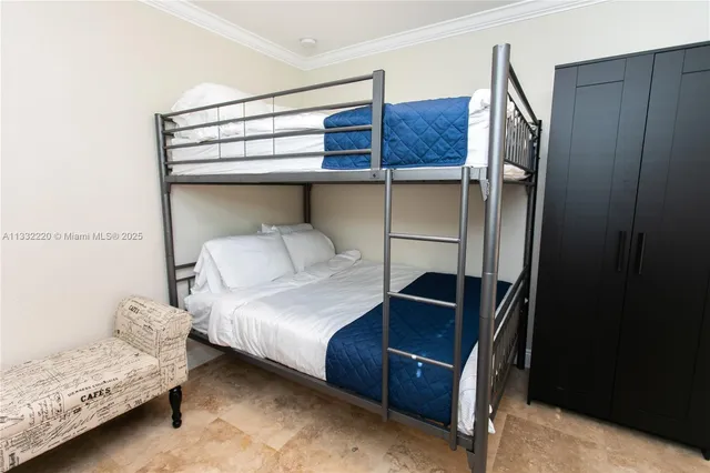 a bedroom with a bed and cabinets