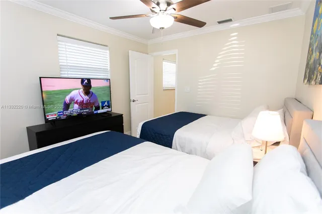 a bedroom with a bed and a flat screen tv