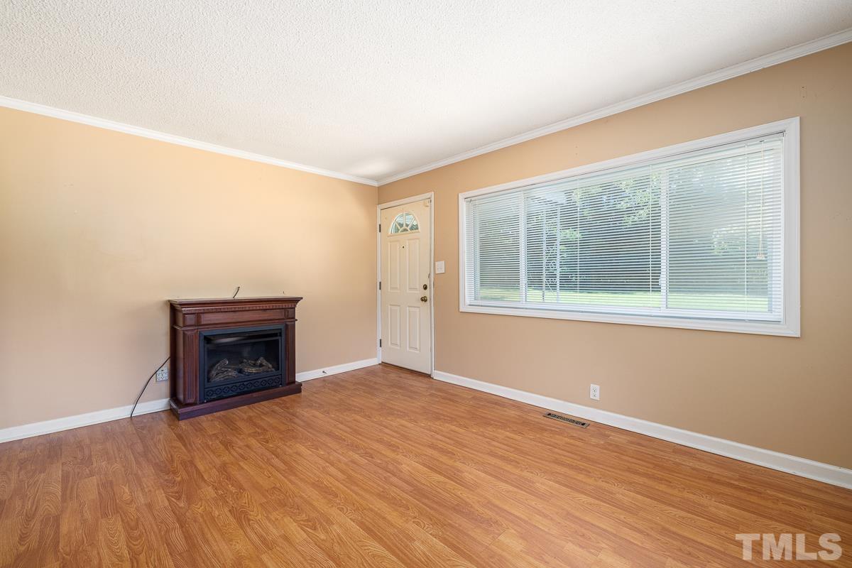 135 Goodwin Road Durham, NC 27712 - Photo 15 of 30 a view of an empty room with wooden floor and a window