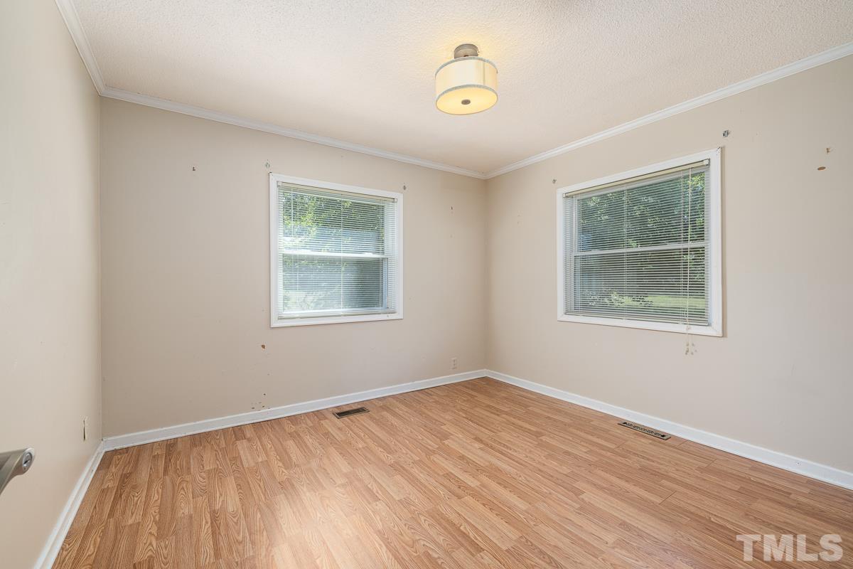 135 Goodwin Road Durham, NC 27712 - Photo 25 of 30 a view of an empty room with wooden floor and a window