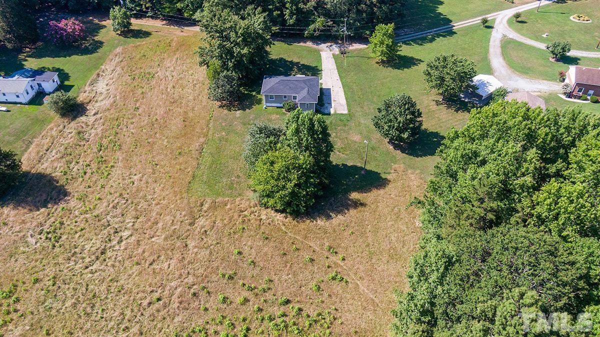 135 Goodwin Road Durham, NC 27712 - Photo 9 of 30 a view of a yard with plants and large trees
