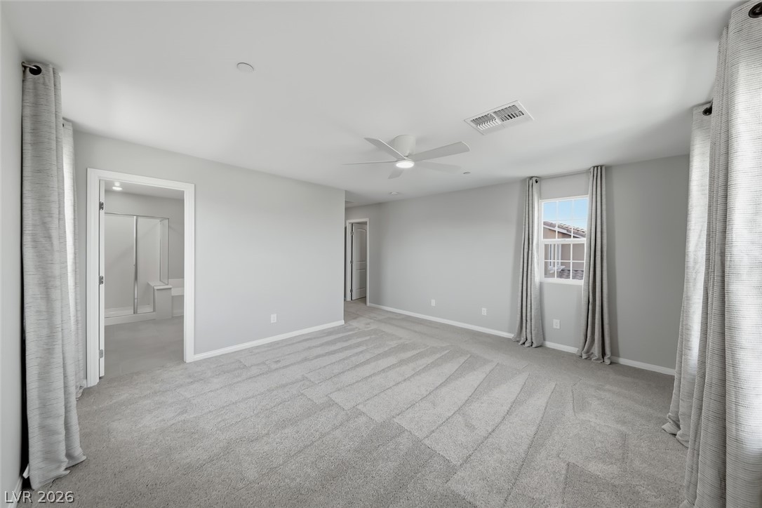 3564 Credere Lane Henderson, NV 89074 - Photo 17 of 40 Unfurnished bedroom with ceiling fan, light carpet, and connected bathroom